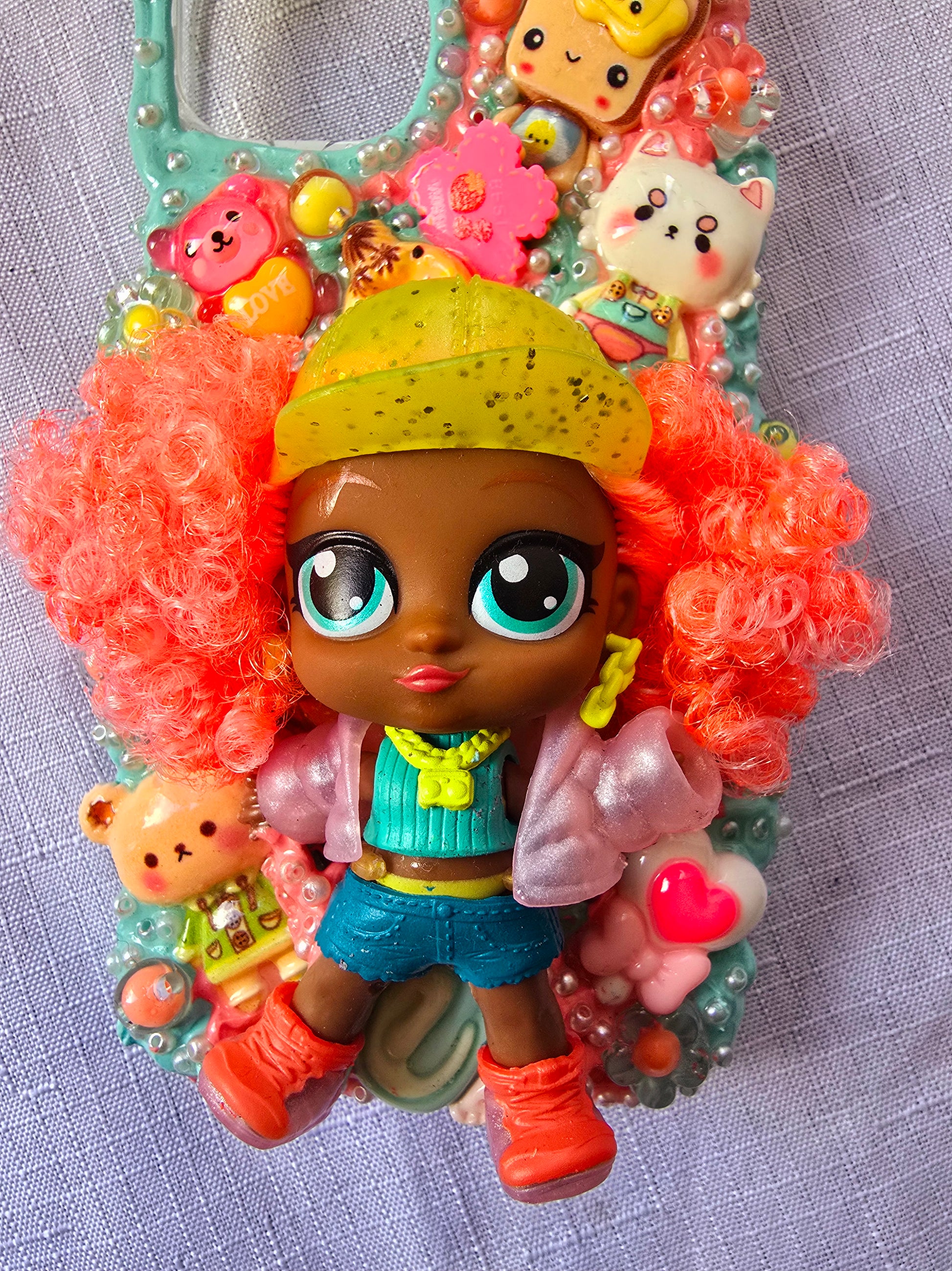 A handmade blue and pink iPhone 13 phone case