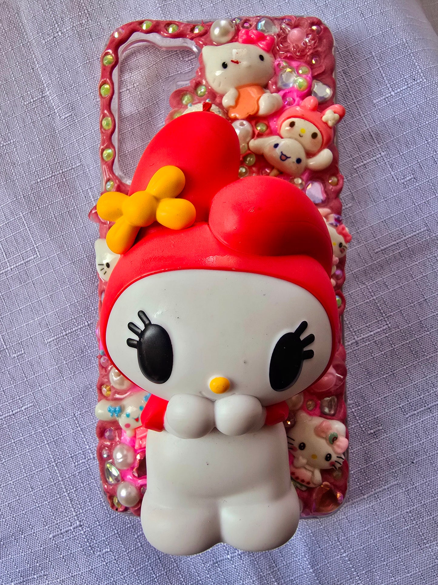 Handmade Samsung S23 Plus phone case featuring a My Melody theme in pink, white, and yellow with cute 3D decorations and kawaii charm accents.