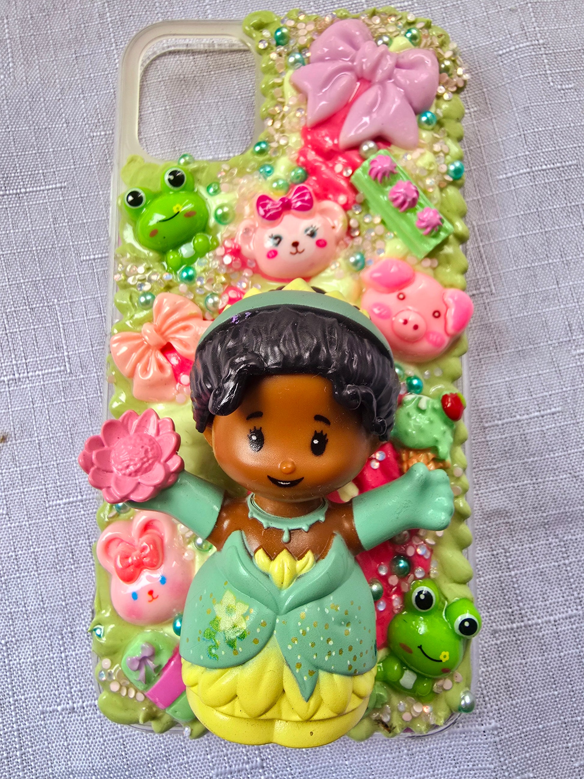 Handmade iPhone 11 phone case in green and pink, featuring a princess theme with floral, animal, and bow accents – cute and whimsical design.