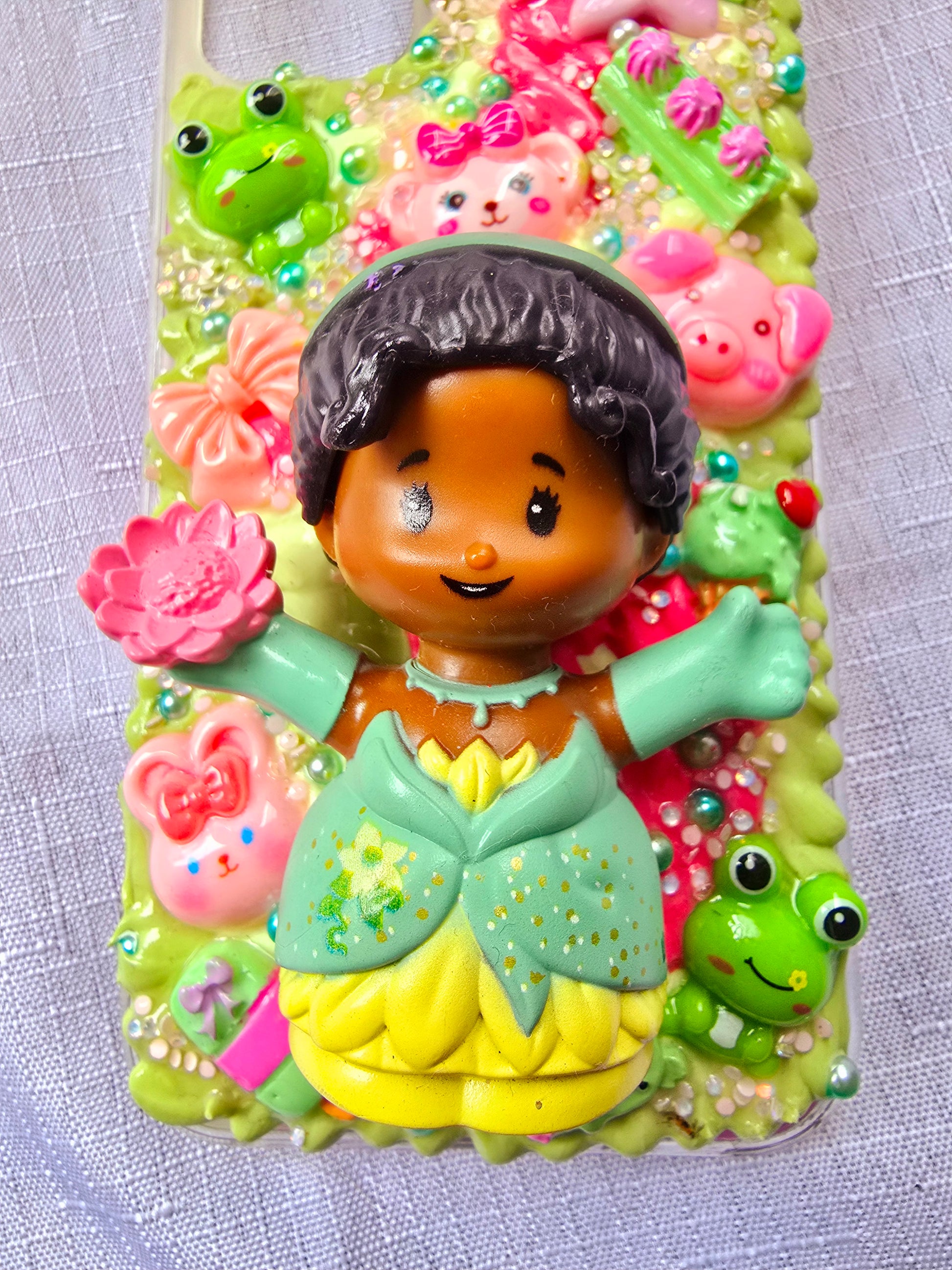 Handmade iPhone 11 phone case in green and pink, featuring a princess theme with floral, animal, and bow accents – cute and whimsical design.