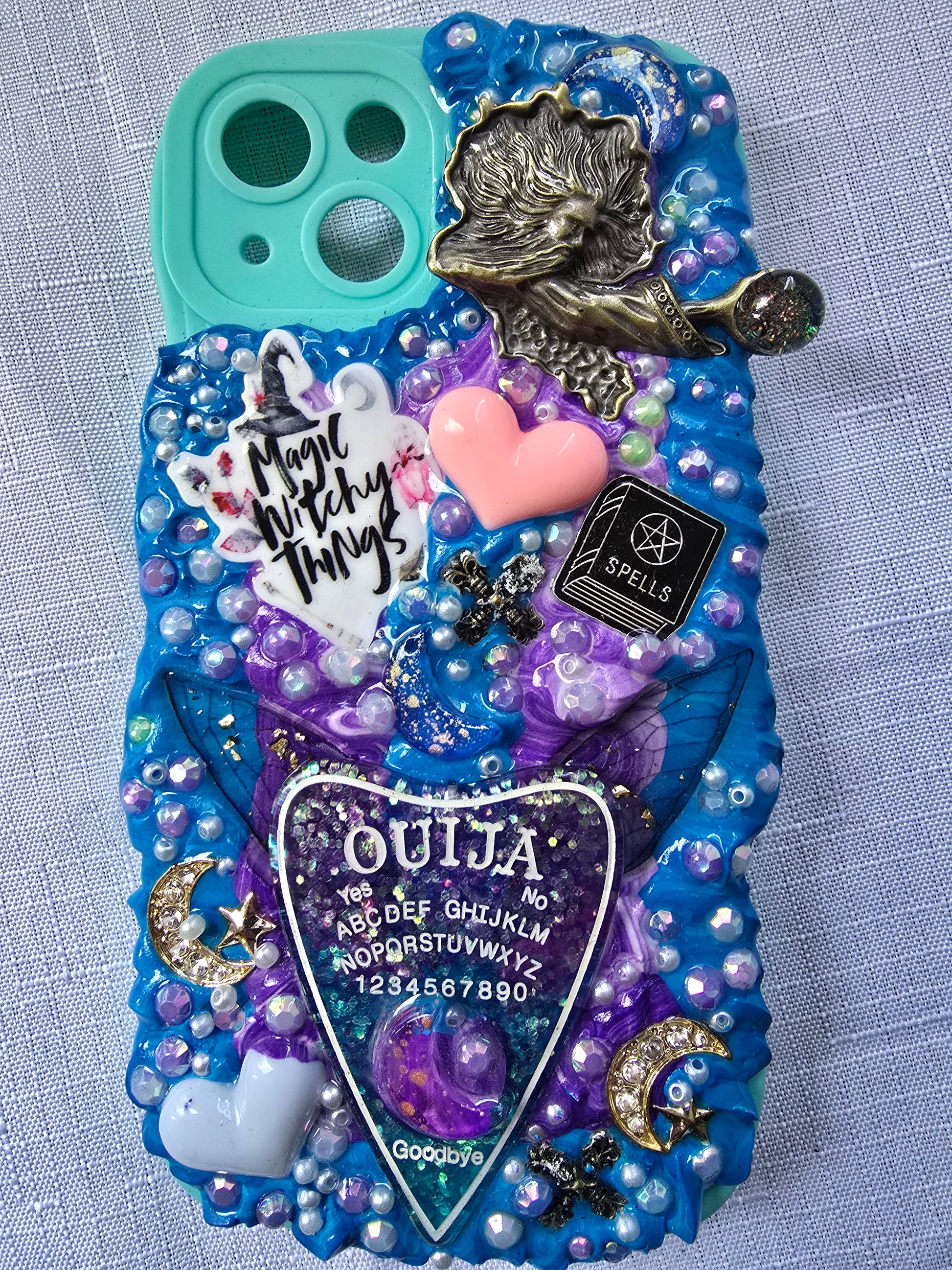 Handmade iPhone 13 phone case in blue and purple with a spiritual and witchy aesthetic, featuring mystical and magical-themed decorations.