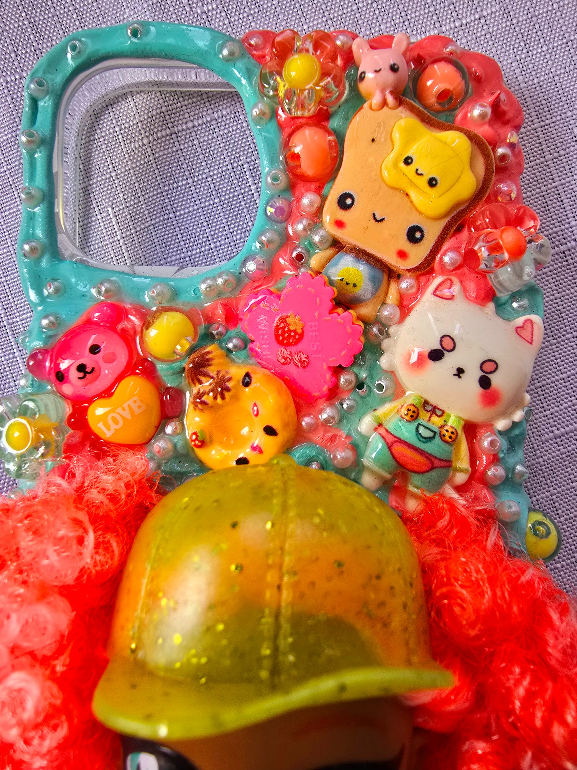 A handmade blue and pink iPhone 13 phone case