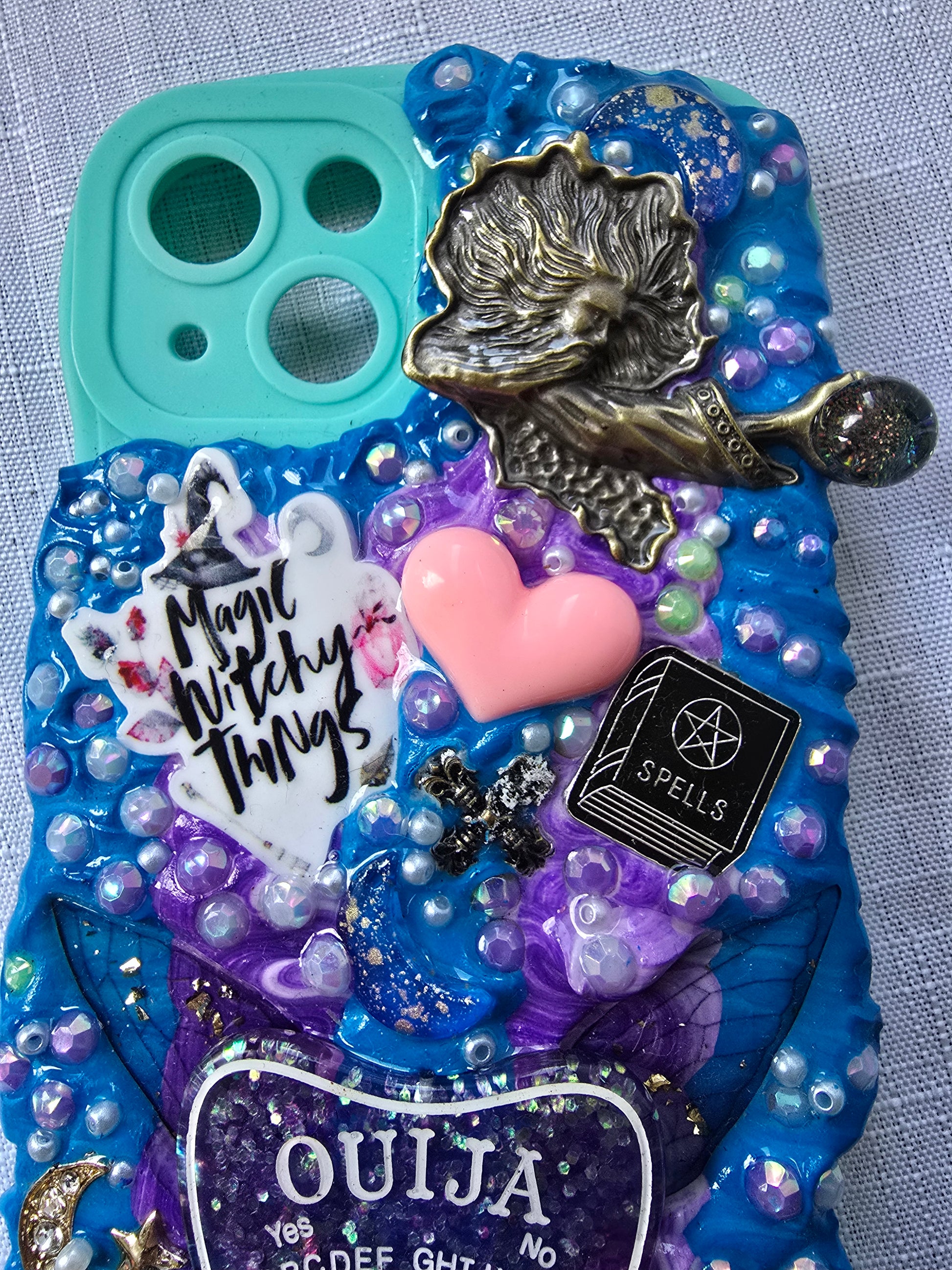Handmade iPhone 13 phone case in blue and purple with a spiritual and witchy aesthetic, featuring mystical and magical-themed decorations.