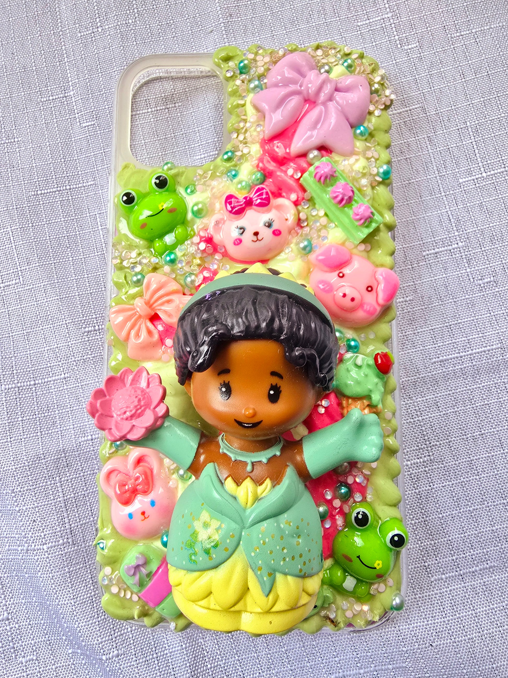 Handmade iPhone 11 phone case in green and pink, featuring a princess theme with floral, animal, and bow accents – cute and whimsical design.