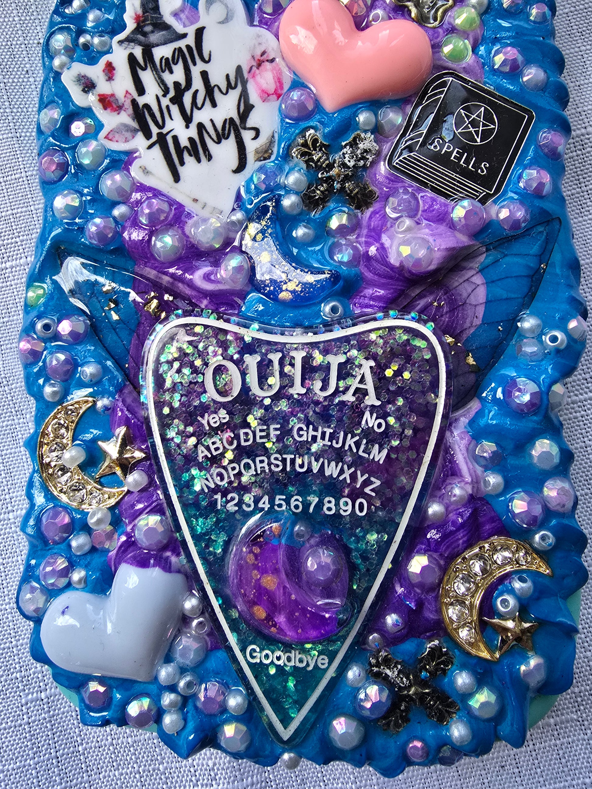 Handmade iPhone 13 phone case in blue and purple with a spiritual and witchy aesthetic, featuring mystical and magical-themed decorations.
