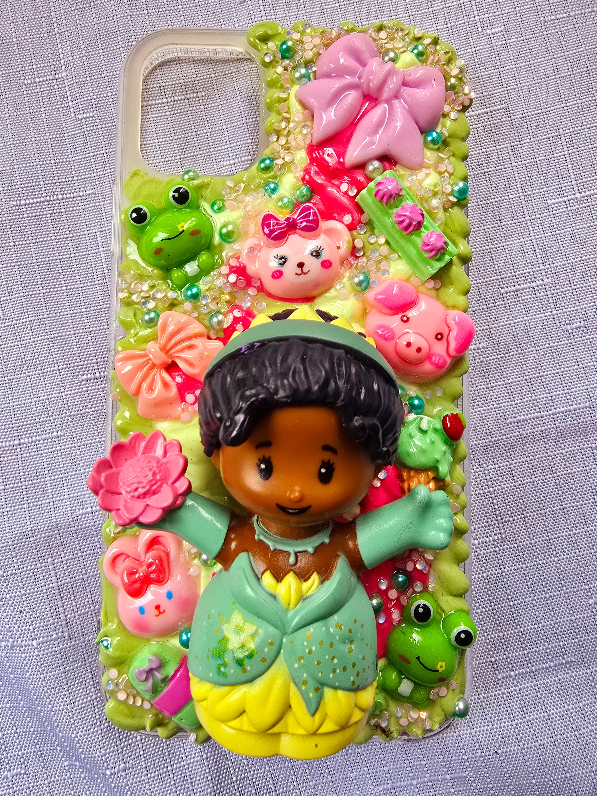 Handmade iPhone 11 phone case in green and pink, featuring a princess theme with floral, animal, and bow accents – cute and whimsical design.